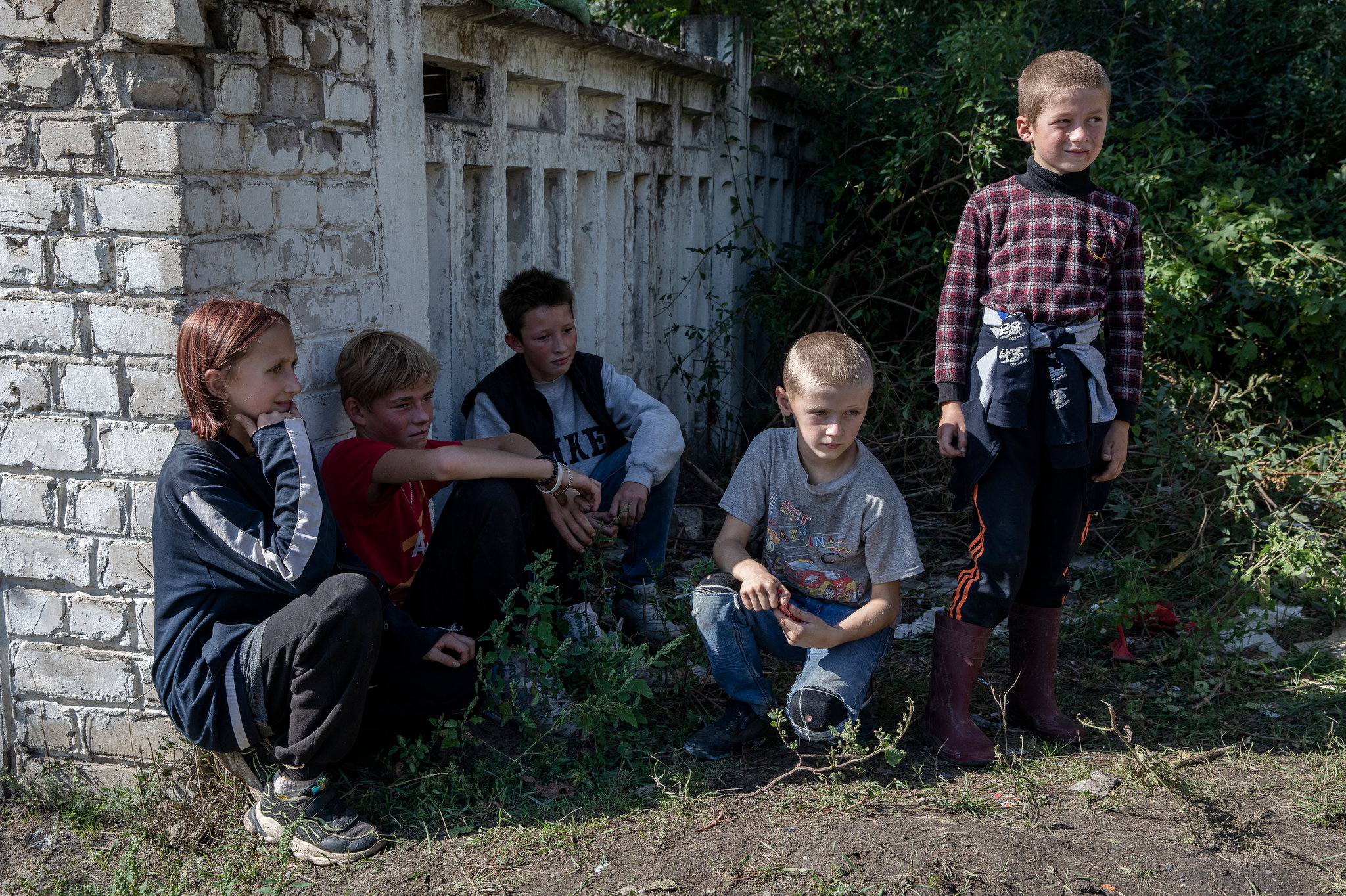 Kids play by the side of the street, in recently liberated Izyum, Ukraine, on September 18, 2022. CREDIT: Adrienne Surprenant / MYOP for The Wall Street Journal KHARKIV